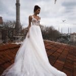 Bride wears A-line wedding dress Dastin by Blammo-Biamo with lace leaves straps, sweetheart bodice, and tulle skirt, image 1