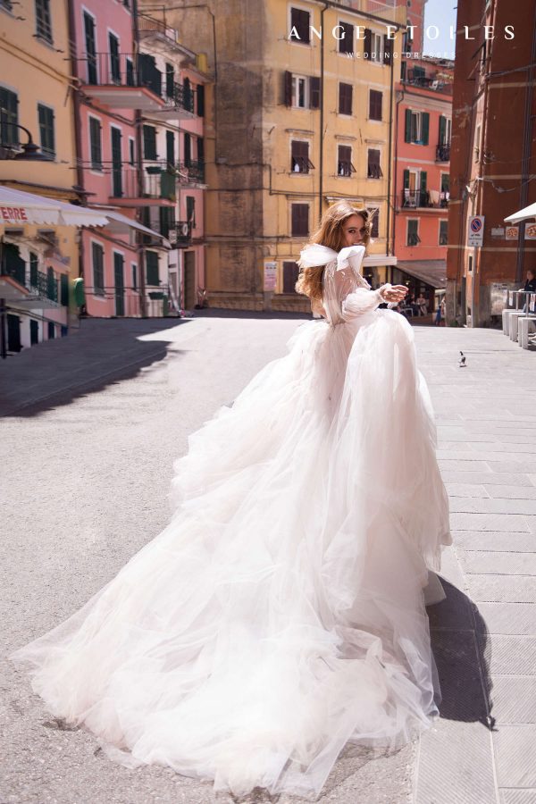 Popular blush colour wedding dress Gretta by Ange Etoiles has dramatic tulle bow and long sleeve on one shoulder, princess puffy skirt and long tulle train, image 2