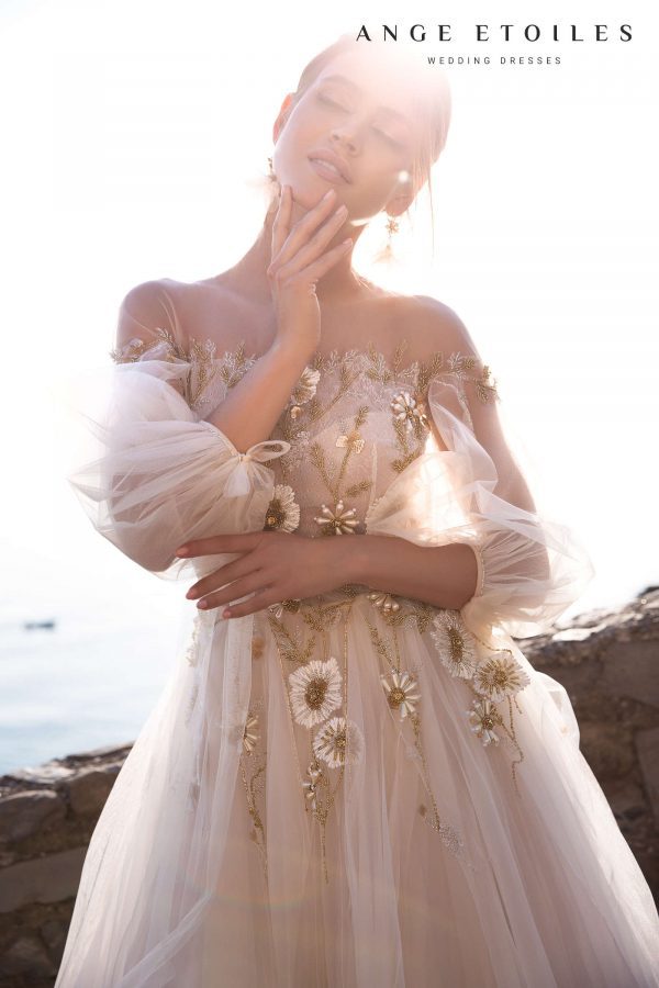 Popular princess wedding gown Lola by ange Etoiles with illusion neckline, off-shoulder long sleeves and decorated with big beaded flowers on the bodice and upper skirt, image 2