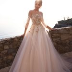 Popular princess wedding gown Lola by ange Etoiles with illusion neckline, off-shoulder long sleeves and decorated with big beaded flowers on the bodice and upper skirt, image 1