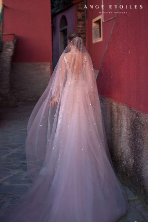 Dell'amore bride wearing a floor length white veil with sequins