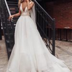 Bride wears white a-line style dress Elba by Rara Avis with wings and deep cut neckline, image 2