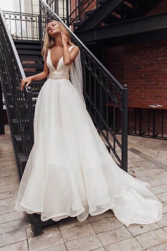Bride wears white a-line style dress Elba by Rara Avis with wings and deep cut neckline, image 2