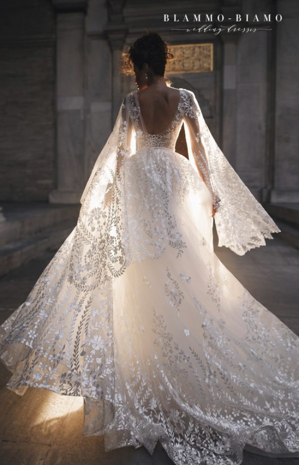 A bride wearing lace princess wedding dress Nilsa by Blammo-Biamo with long flared lace sleeves, image 2