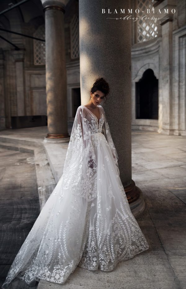 A bride wearing lace princess wedding dress Nilsa by Blammo-Biamo with long flared lace sleeves, image 4