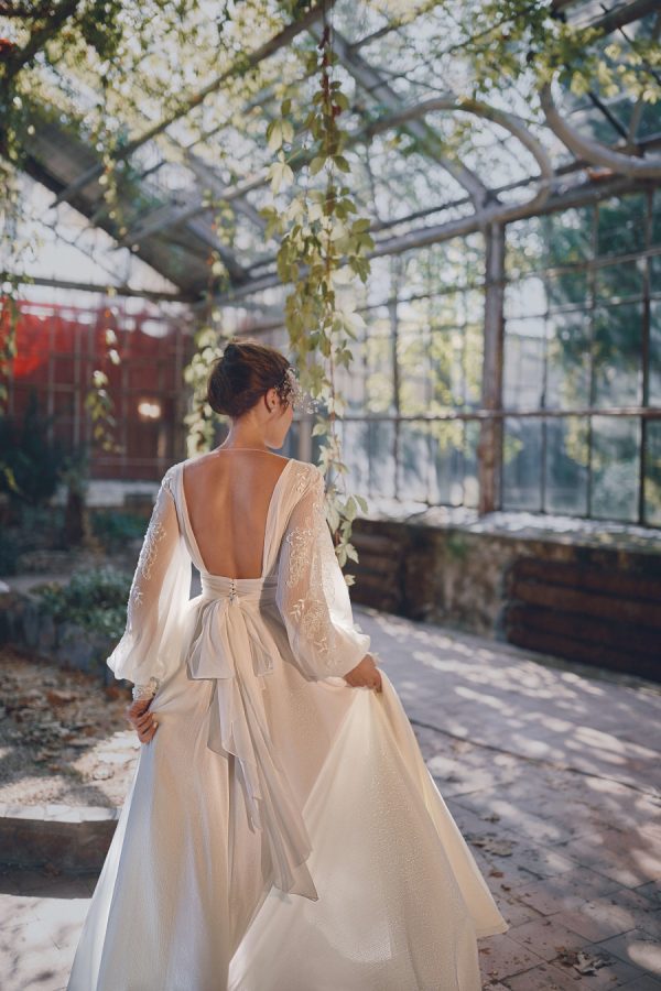 Wedding gown with an open back and long sleeves