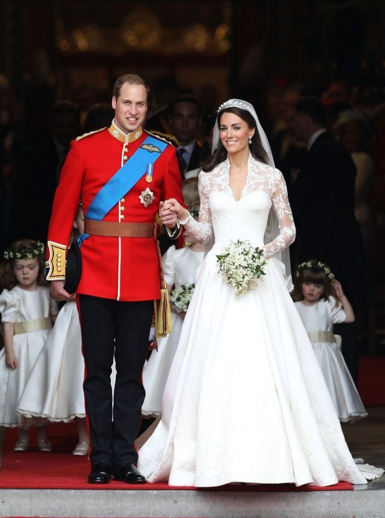 Kate Middleton wearing a princess wedding dress with a lace v-neckline