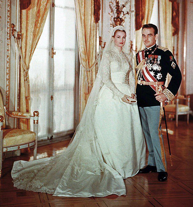 Grace Kelly wearing her white and silky bridal gown and the veil