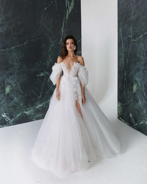A-line silhouette wedding dress Melissa with the split on the skirt and off-shoulder sleeves