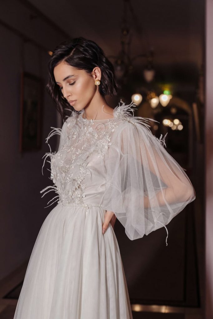  Roseau wedding dress by ange etoiles with boat neckline and open back decorated with feathers