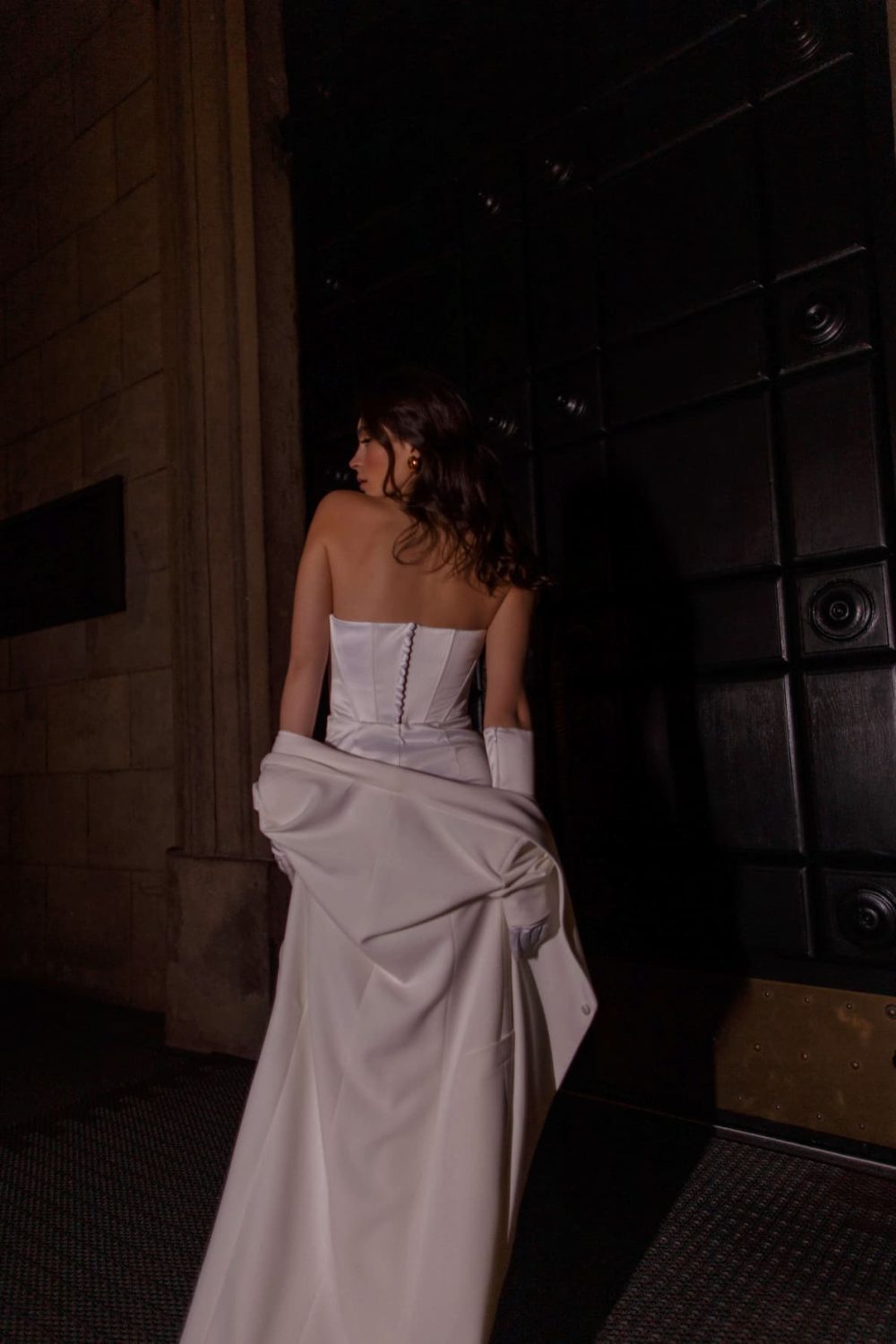 Rara Avis sexy satin corset wedding dress Arha with draping and split on the skirt at Dell'Amore Bridal, NZ.2