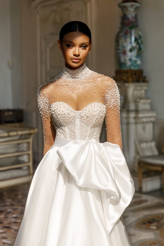 A-line Mirella wedding dress by Oksana Mukha embroidered with pearls and crystals and an attached bow. 1