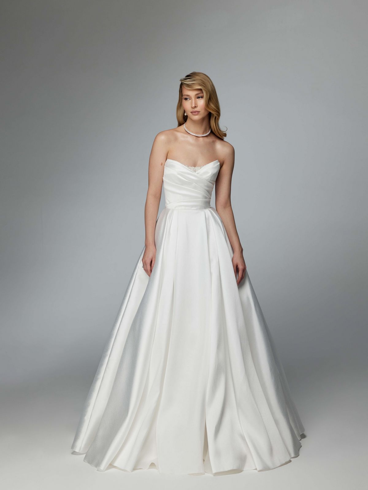 Simple elegant wedding dress with a long train and removable sleeves by ange etoiles. 3
